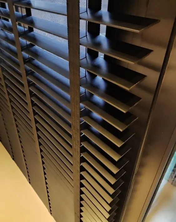 Detalhe das lâminas de uma persiana horizontal em contraluz
